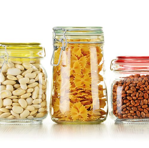 Jars with grain foods isolated on white